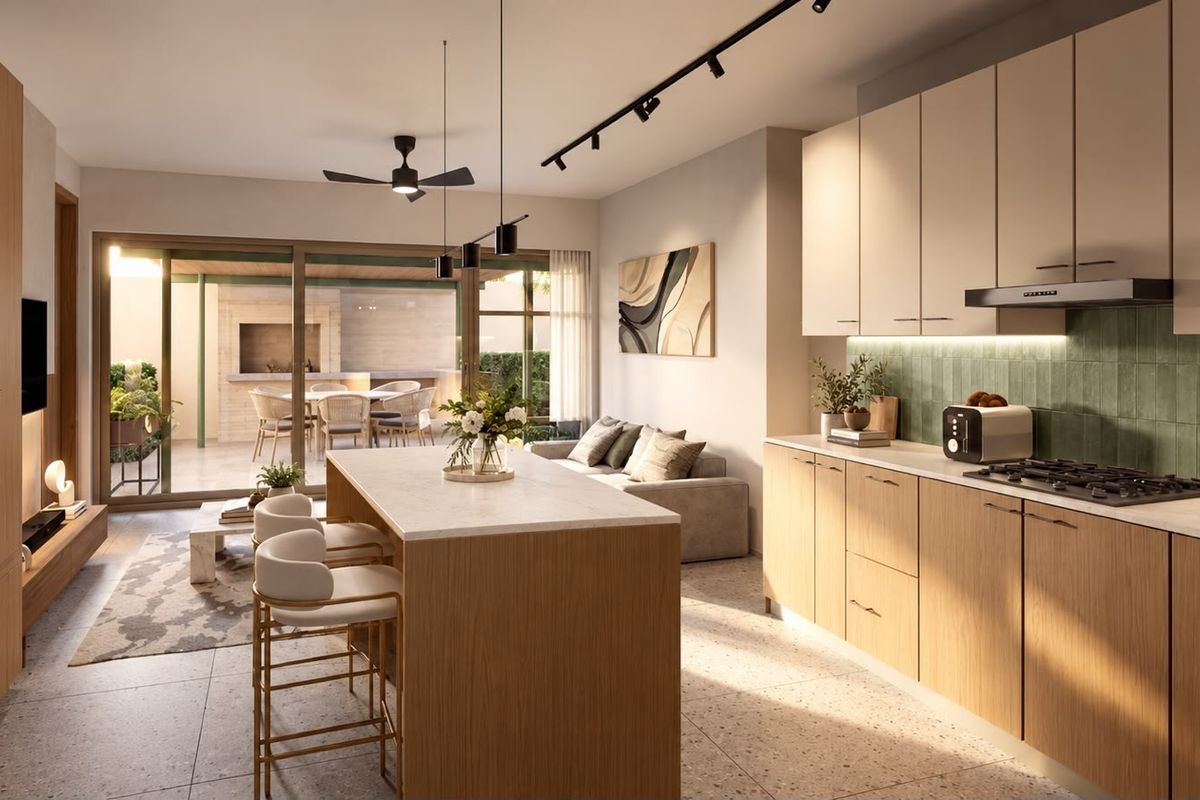 Modern open-plan living area featuring a sleek kitchen with island, high-end finishes, and seamless flow to a covered outdoor patio space.