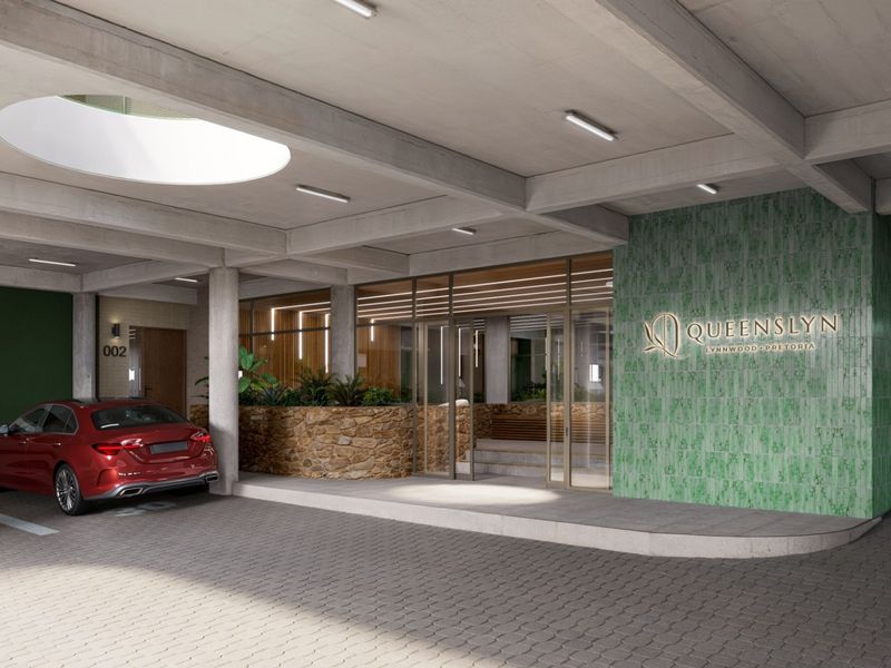 Modern apartment building entrance featuring a paved driveway, stone and green tile accents, and a contemporary glass facade.