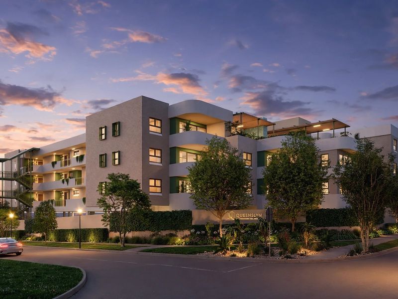 A modern apartment complex exterior at dusk, featuring contemporary architectural design, private balconies, and landscaped grounds.