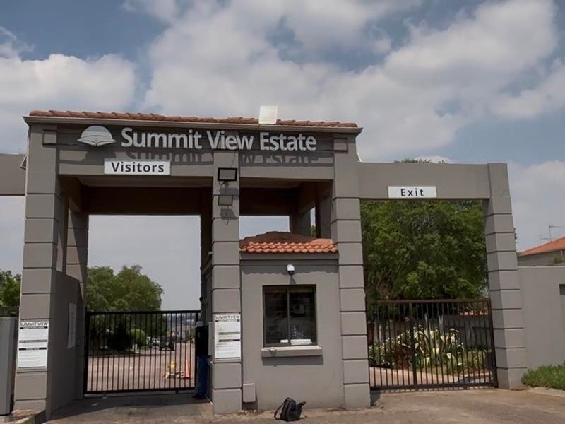 The main entrance gate and security guard house for Summit View Estate, featuring controlled access points for residents and visitors.