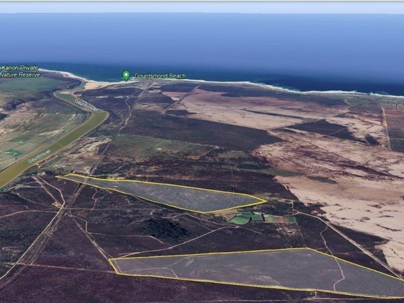Aerial view of the farm property highlighting its expansive land, proximity to the river, and coastal location near Gouritsmond Beach.