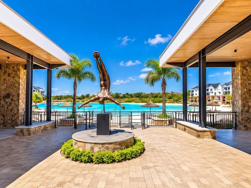 A beautifully landscaped outdoor pool area featuring stone-clad pillars, timber ceilings, and a central sculpture overlooking a large swimming pool.