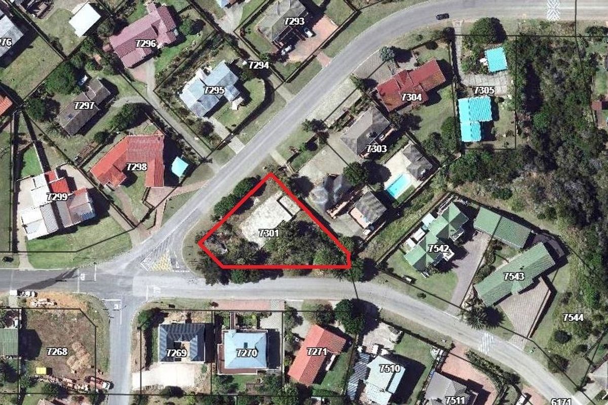 Aerial view of a vacant residential land parcel highlighted with a red boundary, situated in a developed suburban neighborhood.