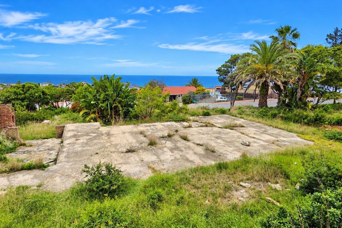 Vacant residential land featuring a concrete slab foundation, brick retaining wall, and scenic ocean views.