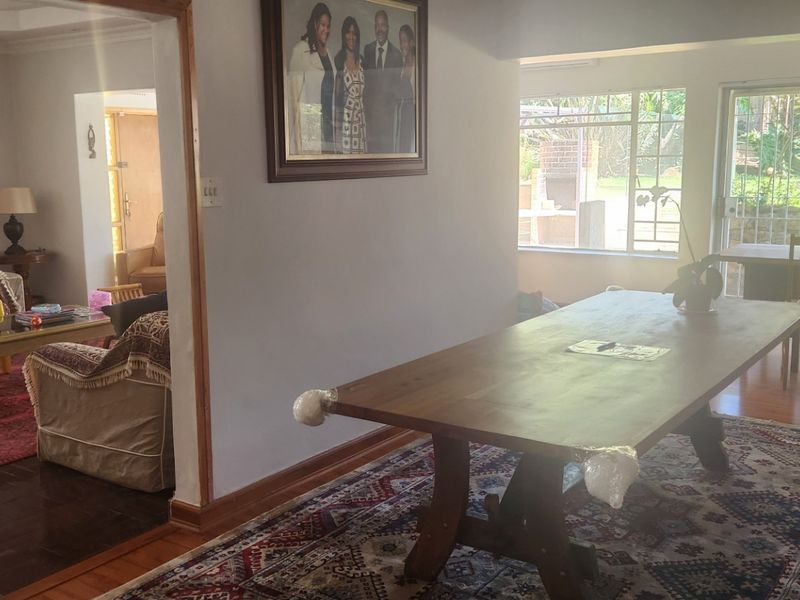 Dining area featuring hardwood flooring and large sliding glass doors providing natural light and access to the outdoor space.