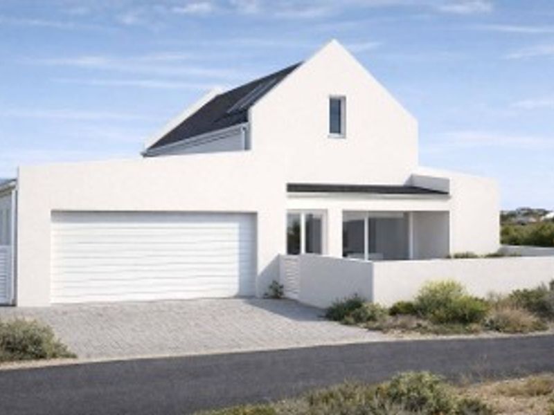 A modern white house exterior featuring a clean gabled roof design, a single garage, and a paved driveway.