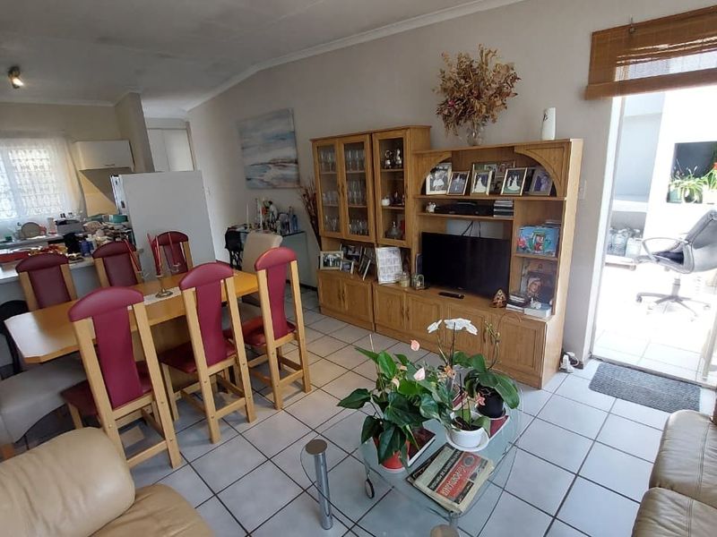 Open plan living and dining area featuring tiled flooring and direct access to an outdoor patio space.