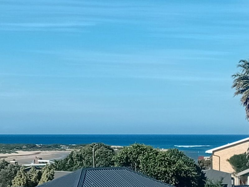 A scenic elevated view overlooking the coastline, ocean, and surrounding landscape.