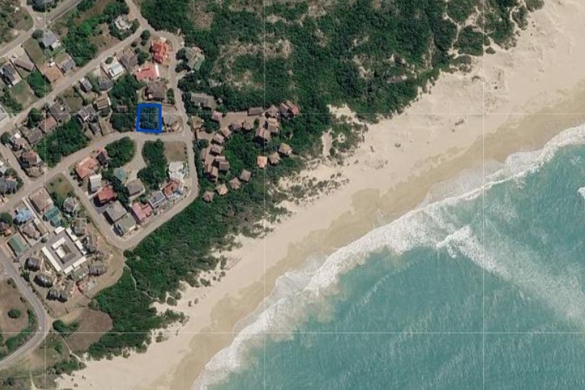 Aerial view of a residential land parcel located within a coastal estate, highlighting its proximity to the beach and surrounding neighborhood infrastructure.