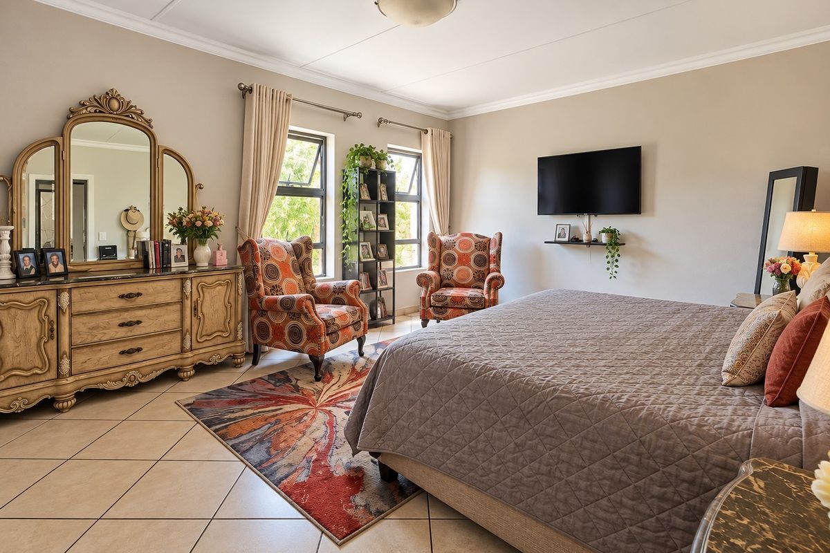 Spacious bedroom featuring neutral wall tones, tiled flooring, and large windows that provide ample natural light.