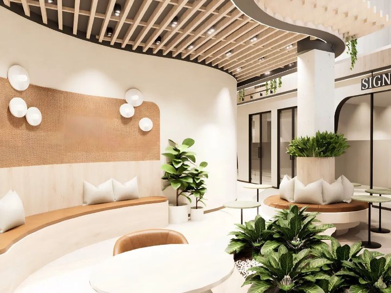 Modern office reception area featuring a curved built-in bench, slatted timber ceiling details, and contemporary glass partitions in a bright, professional workspace.