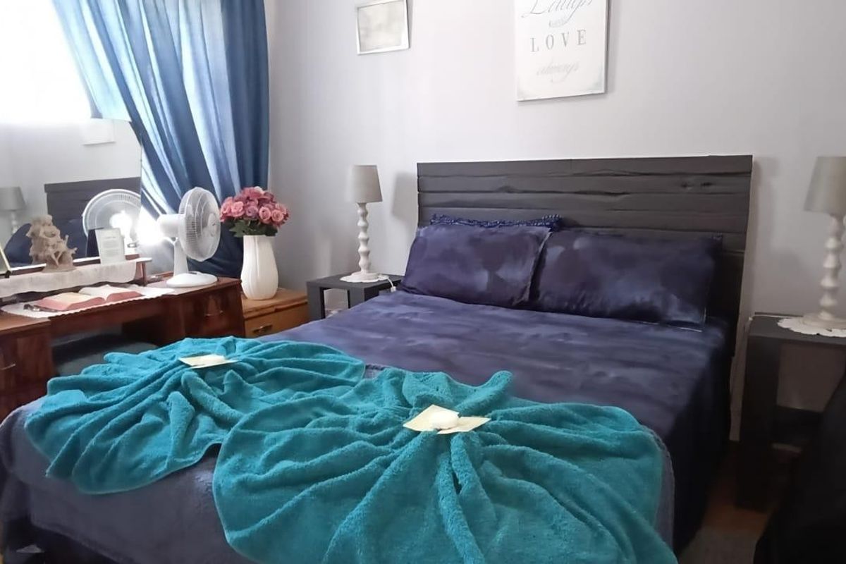 A standard bedroom featuring neutral wall finishes and space for a double bed.