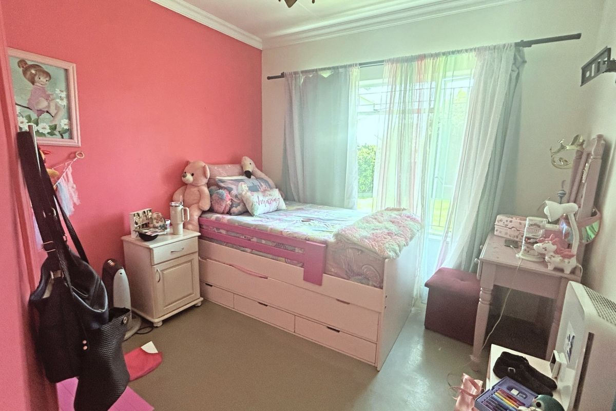 A bedroom featuring a sliding glass door with curtain rod and decorative coving, providing access to the exterior.