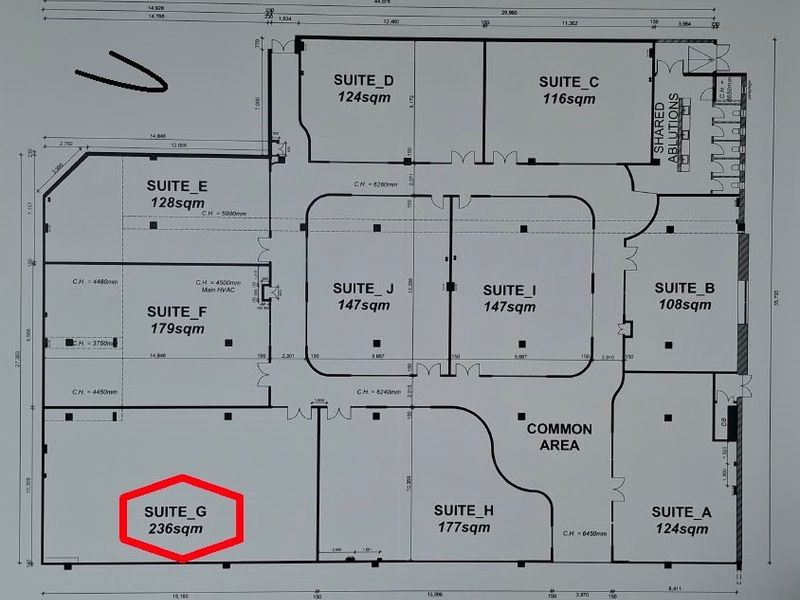 A detailed architectural floor plan showing the layout of multiple office suites and a common area within the commercial property.