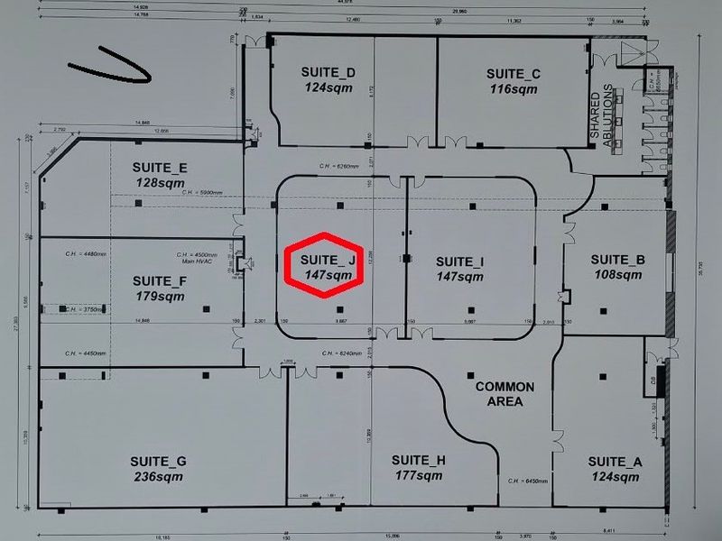 Architectural floor plan showing the layout of multiple office suites, shared ablutions, and a common area within the commercial property.