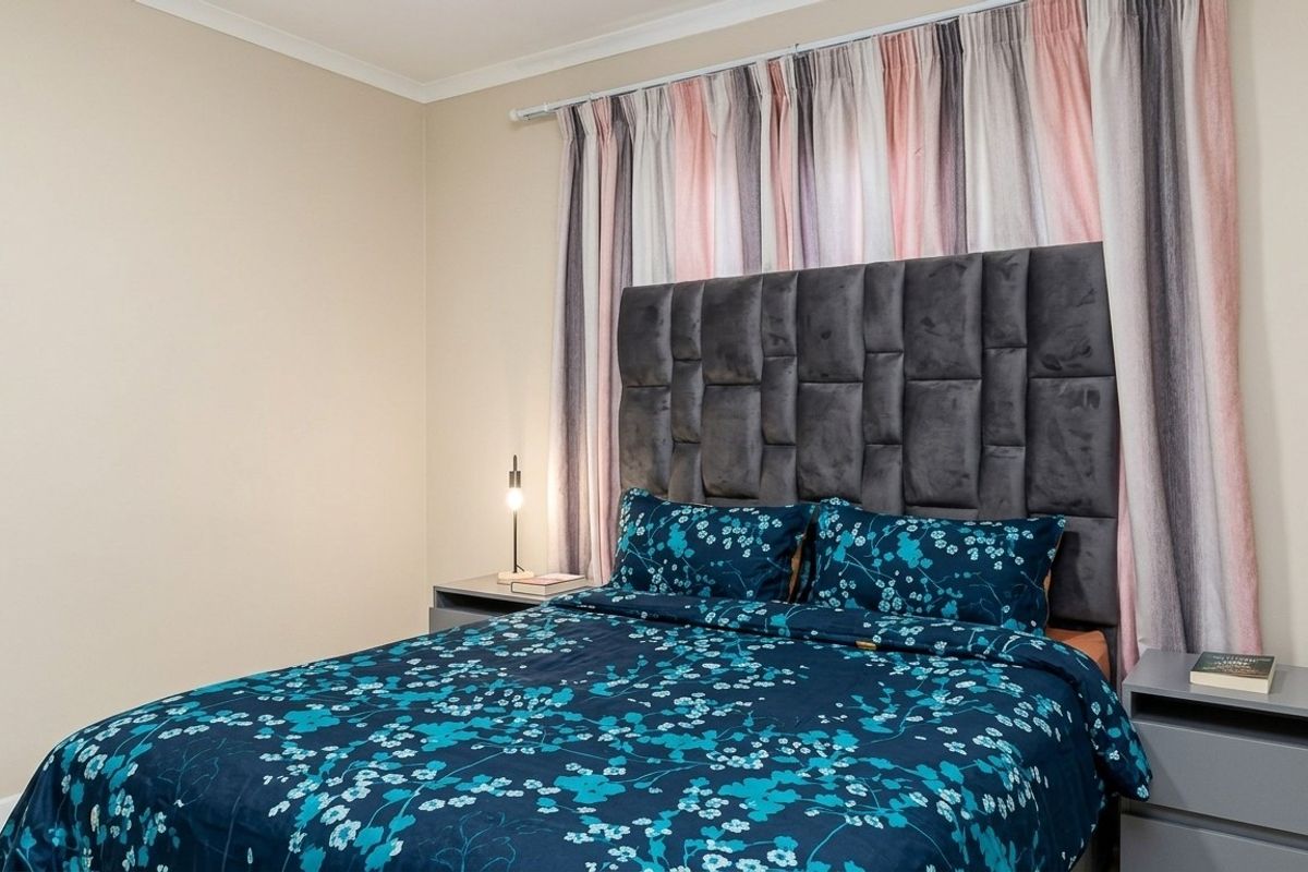A well-maintained bedroom featuring neutral wall finishes and a clean, modern aesthetic.