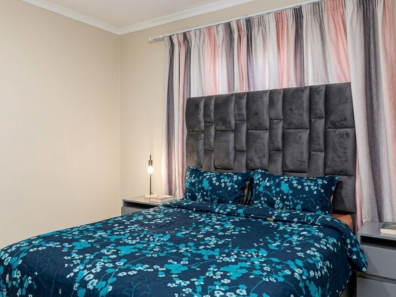 A well-maintained bedroom featuring neutral wall finishes and a clean, modern aesthetic.