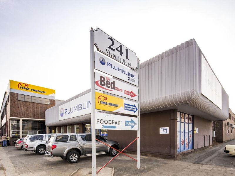 Commercial property frontage on Victoria Road featuring prominent tenant signage, paved parking access, and modern metal cladding facade elements.