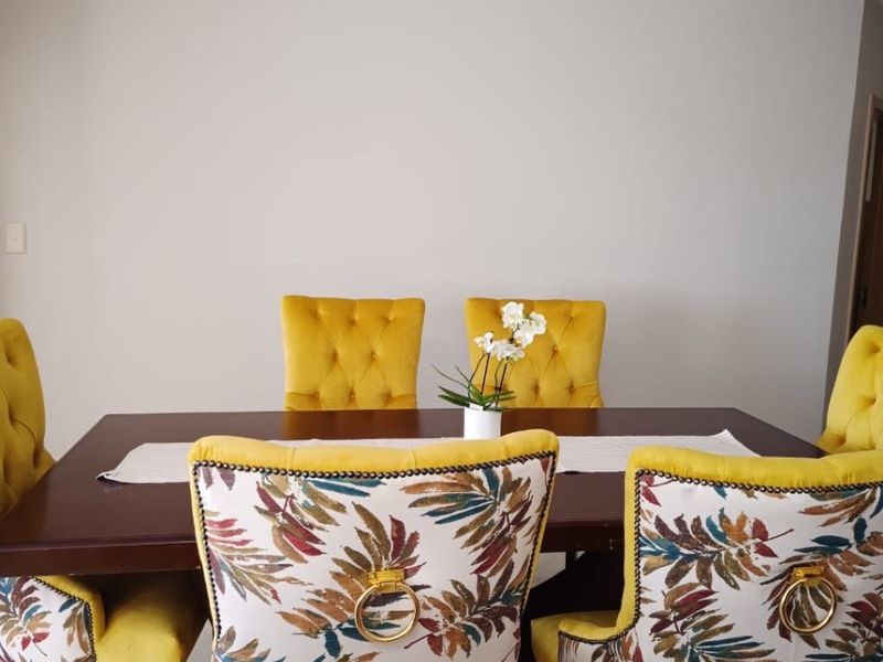 A well-maintained dining area featuring neutral wall finishes and clean tiled flooring, providing a bright and functional space for meals.
