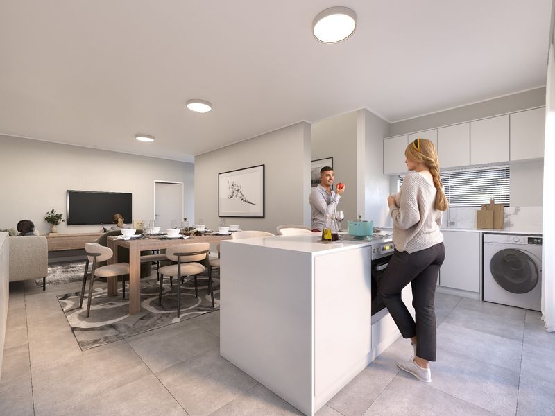 Modern open-plan living area featuring a sleek kitchen with white cabinetry, a central island, built-in appliances, and neutral tiled flooring throughout.