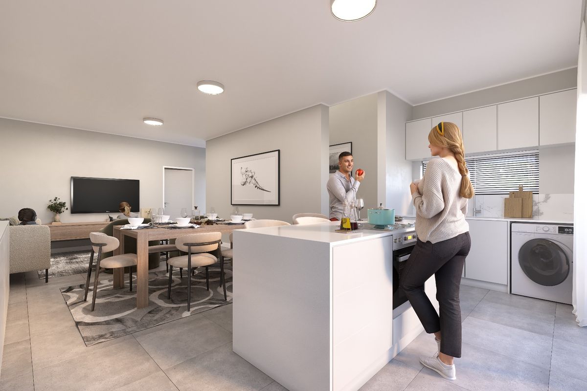 Modern open-plan living area featuring a sleek kitchen with white cabinetry, a central island, built-in appliances, and neutral tiled flooring throughout.