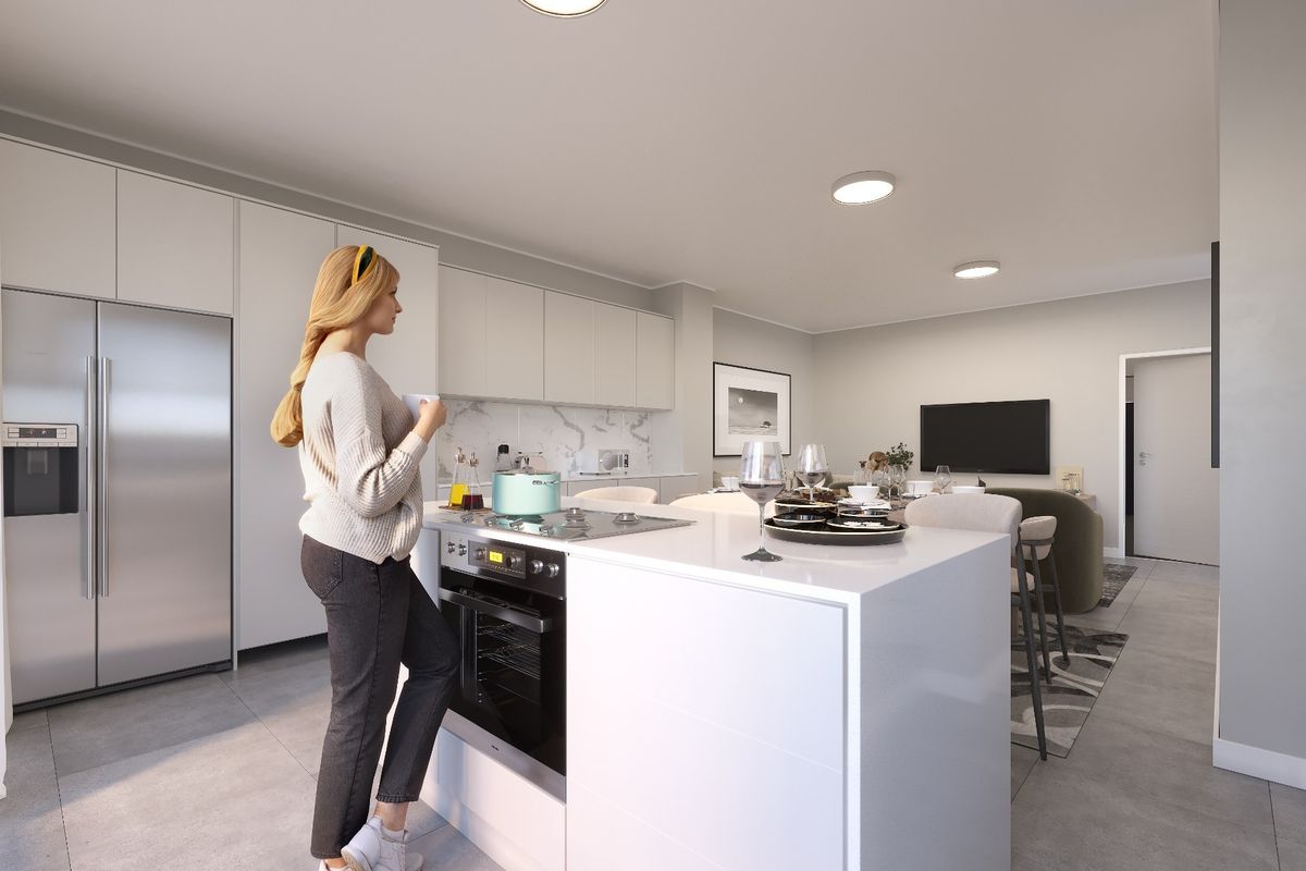 Modern open-plan living area featuring a sleek kitchen island with built-in oven, cooktop, and contemporary cabinetry, seamlessly flowing into the dining and lounge space.