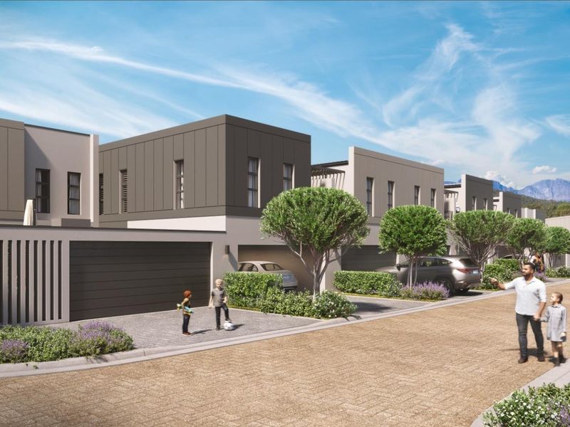 A modern residential townhouse development featuring contemporary architectural design, paved driveways, and integrated garage access within a landscaped estate setting.