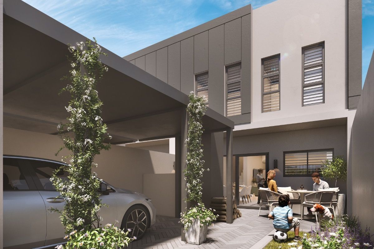Modern rear exterior view featuring a covered carport, herringbone paved driveway, and contemporary architectural finishes with integrated outdoor living space.
