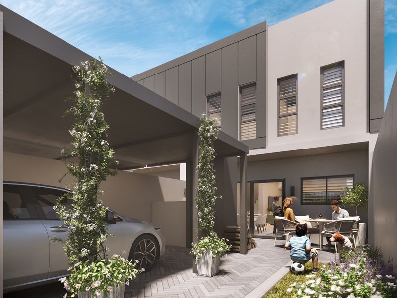 Modern rear exterior view featuring a covered carport, herringbone paved driveway, and contemporary architectural finishes with integrated outdoor living space.