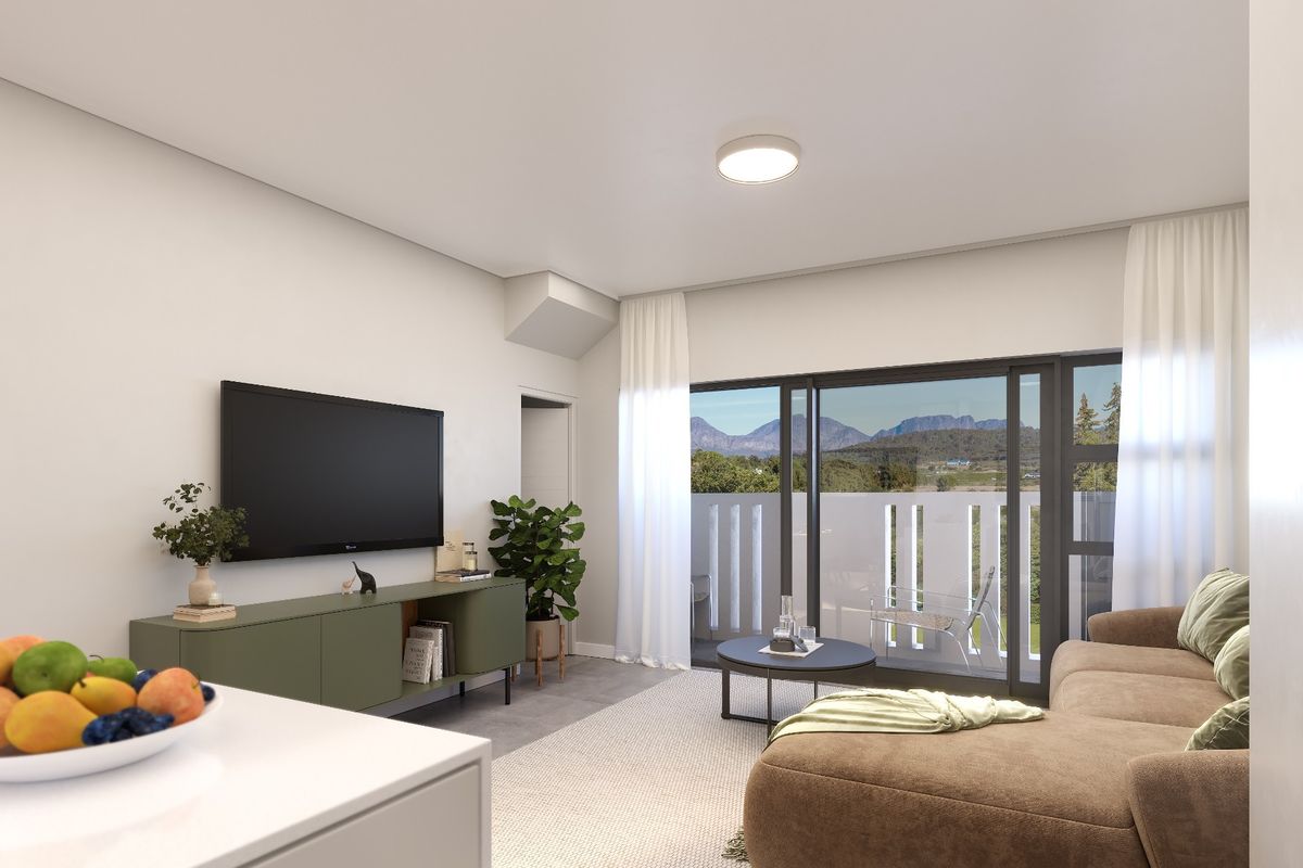 Modern living room featuring large sliding glass doors that open to a balcony with scenic mountain views and neutral tiled flooring.