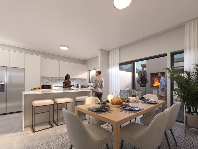 Modern open-plan kitchen and dining area featuring sleek cabinetry, a central island, and seamless flow to an outdoor patio with a built-in fireplace.