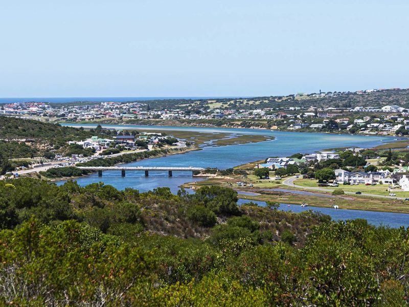 A scenic elevated view overlooking the estuary, bridge, and surrounding coastal residential landscape.