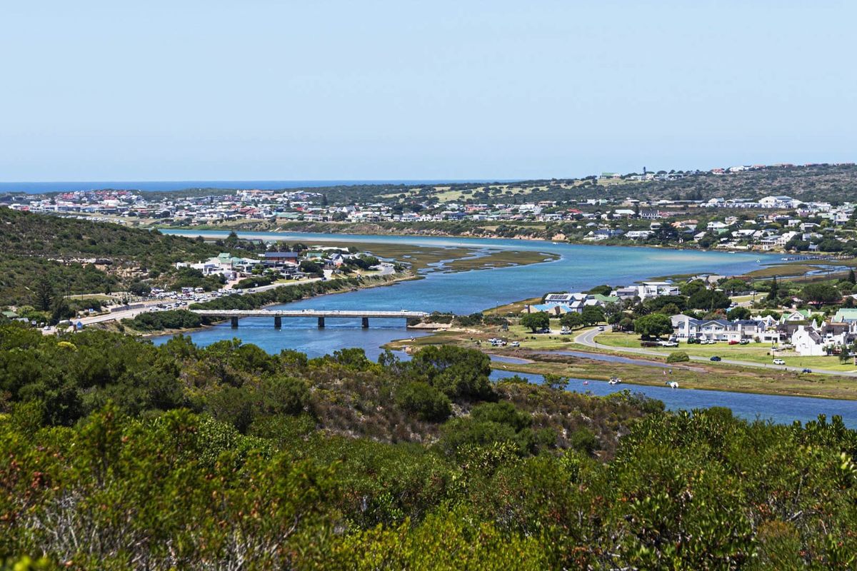 A scenic elevated view overlooking the estuary, bridge, and surrounding coastal residential landscape.