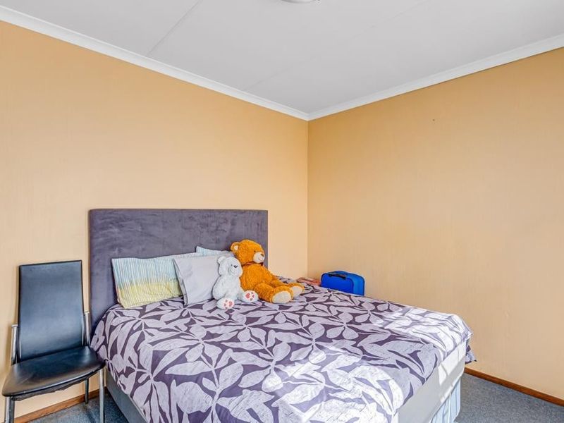 A standard bedroom featuring neutral wall finishes, coving, and carpet flooring, providing a functional and comfortable living space.