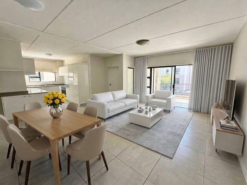 Spacious open-plan living, dining, and kitchen area featuring neutral tiled flooring, modern cabinetry, and large sliding doors leading to a private balcony.