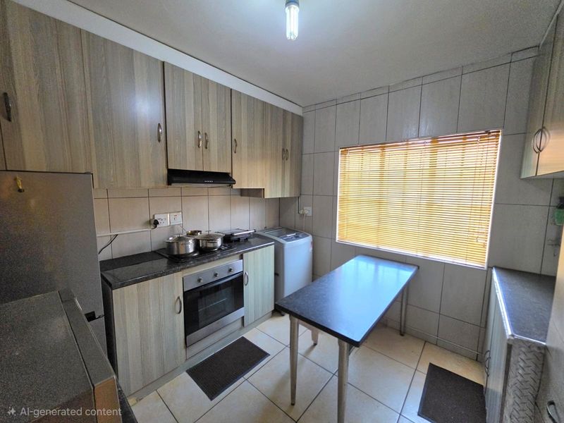A functional kitchen featuring wood-look cabinetry, granite countertops, built-in oven, extractor fan, and tiled finishes throughout.