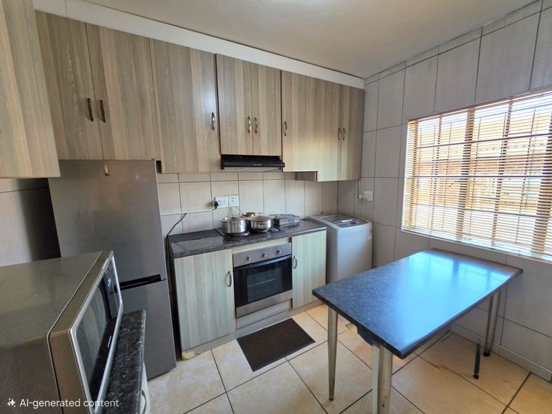 A functional kitchen featuring wood-look cabinetry, built-in oven with extractor fan, tiled backsplash, and tiled flooring, offering a practical layout for daily use.