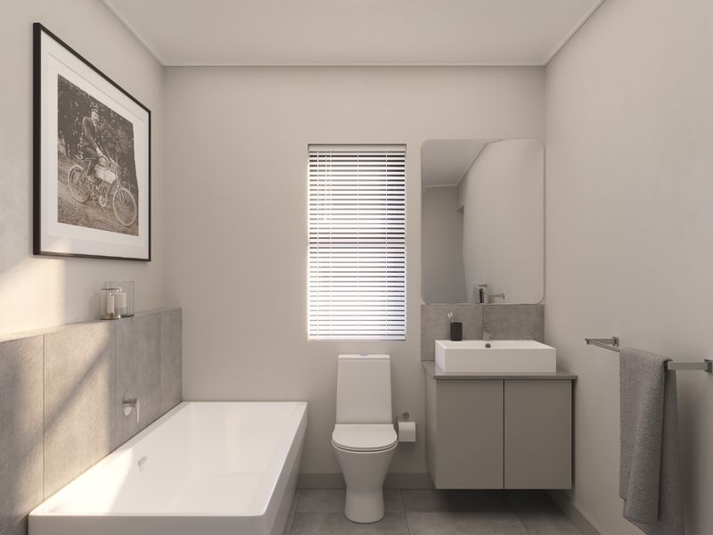 Modern bathroom featuring a sleek wall-mounted vanity, built-in bathtub, and neutral grey tiling, offering a clean and contemporary aesthetic.