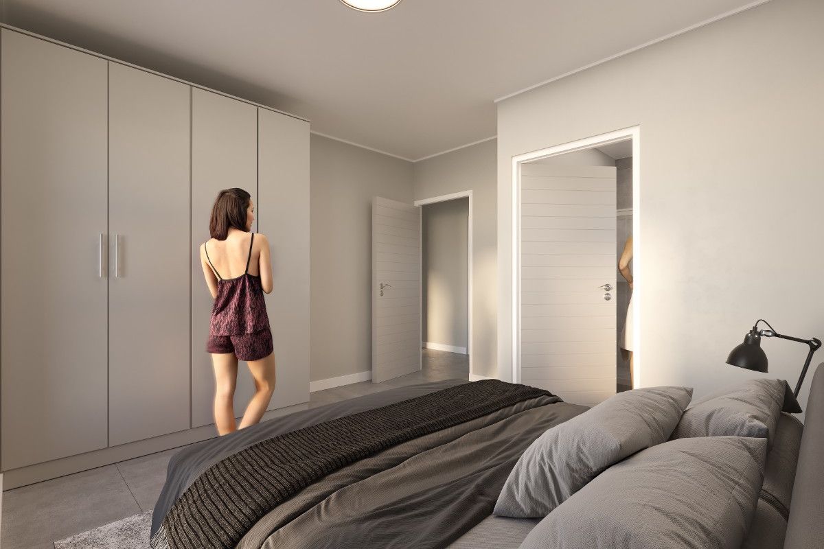 A modern, well-lit bedroom featuring neutral tones, built-in floor-to-ceiling cupboards, and clean architectural lines.
