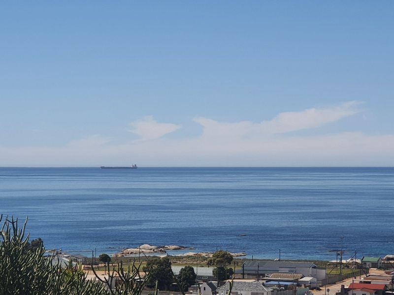 A scenic elevated view overlooking the coastline and ocean, showcasing the expansive horizon and surrounding landscape.