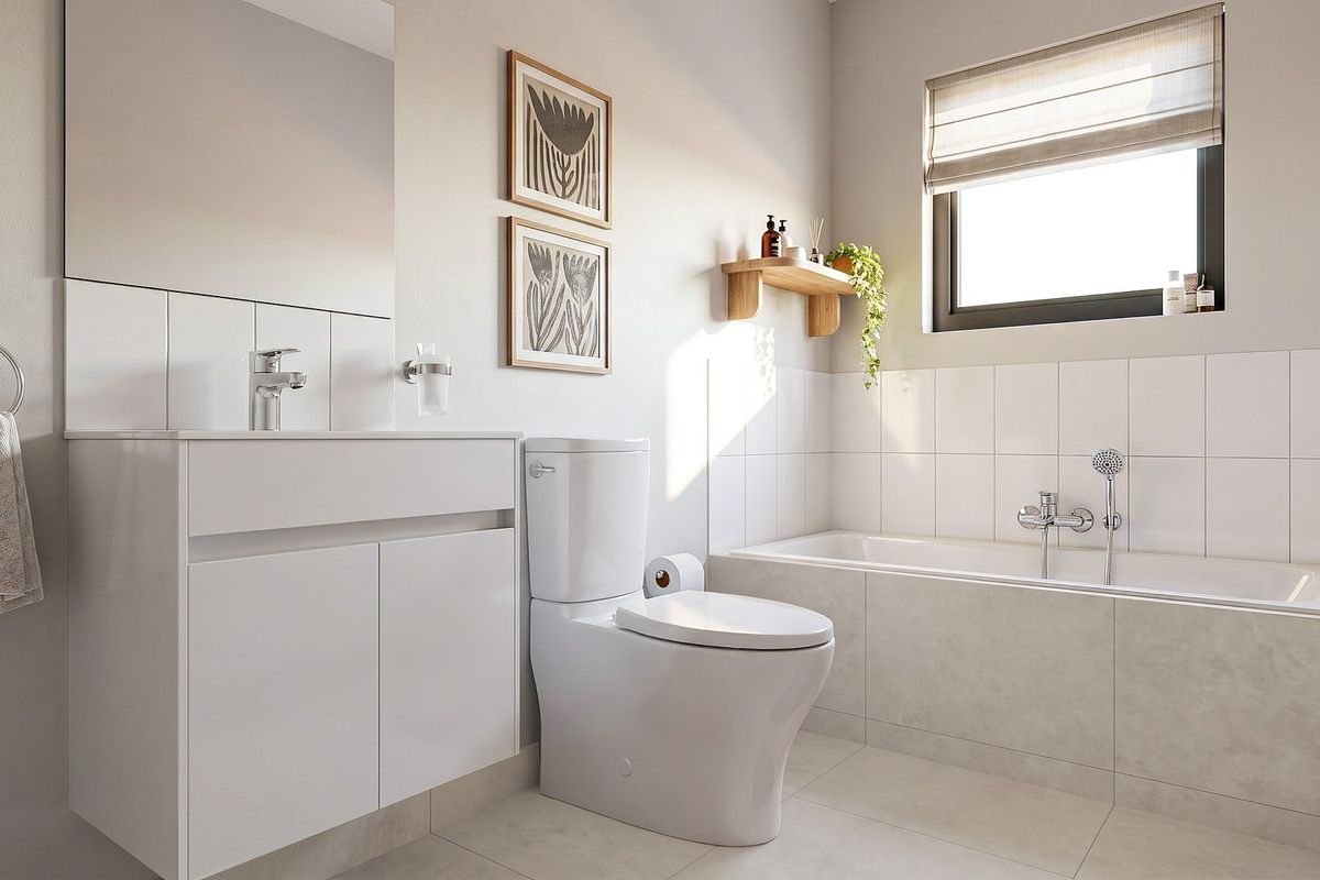 Modern bathroom featuring a clean white vanity, integrated basin, toilet, and a tiled bathtub with shower mixer, finished with neutral wall and floor tiles.