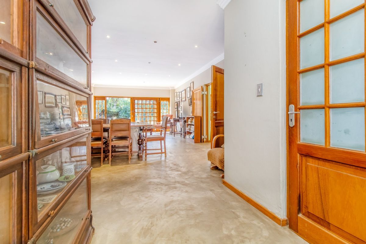 Spacious living area featuring polished concrete flooring, recessed downlighting, and classic timber door frames, creating a warm and inviting atmosphere.