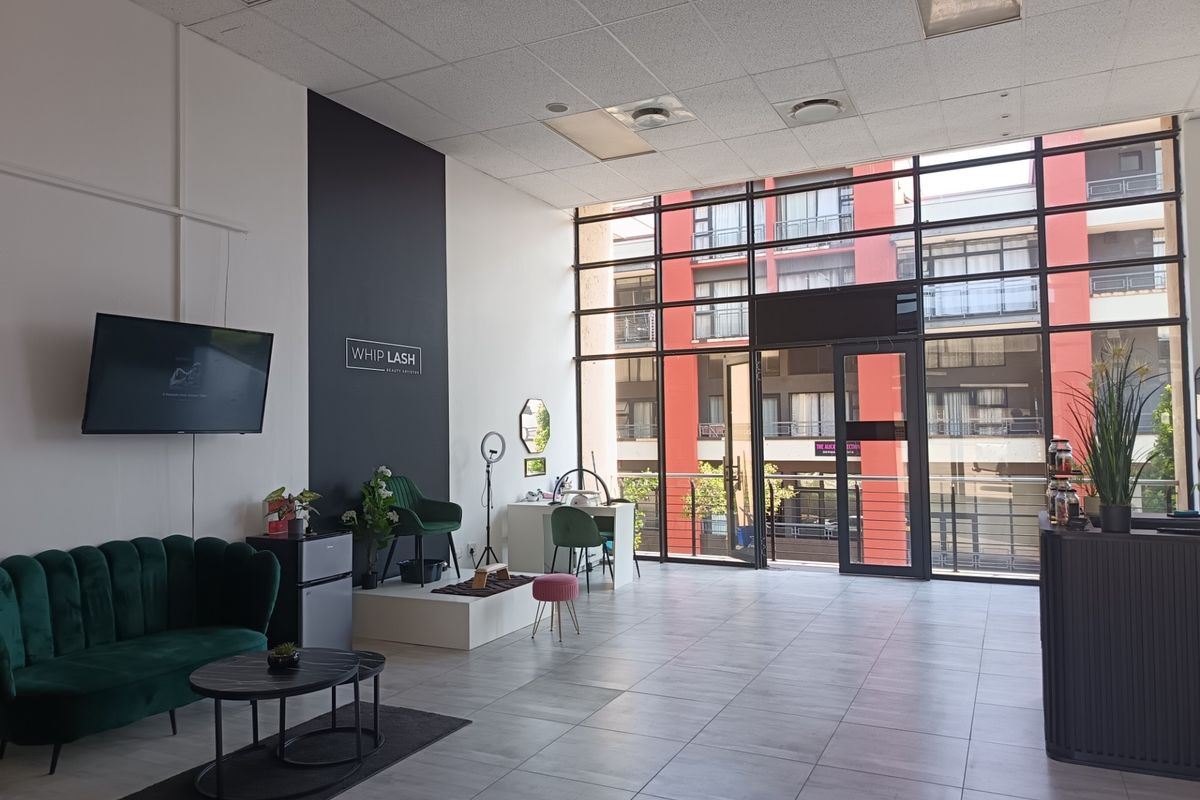 Spacious open-plan retail unit featuring large floor-to-ceiling windows, tiled flooring, and a modern suspended ceiling, providing excellent natural light and visibility.