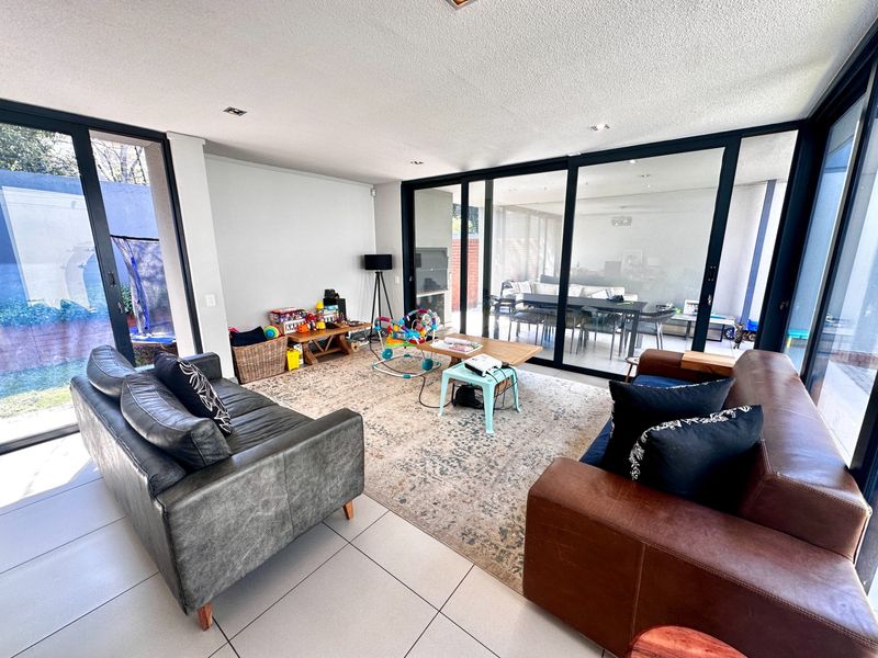 Spacious living room featuring large sliding glass doors that provide abundant natural light and seamless access to the outdoor patio area.