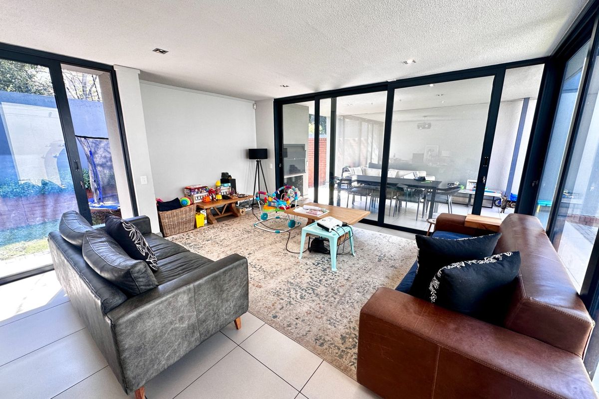 Spacious living room featuring large sliding glass doors that provide abundant natural light and seamless access to the outdoor patio area.