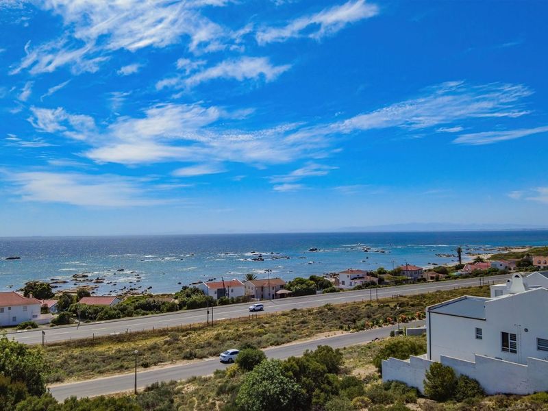 An aerial view of the coastal residential area, showcasing the proximity to the ocean and surrounding landscape.