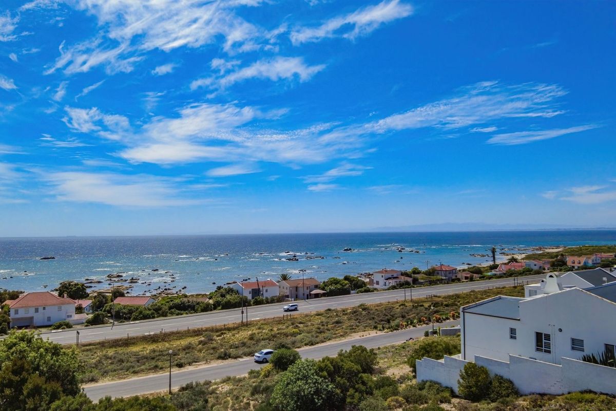 An aerial view of the coastal residential area, showcasing the proximity to the ocean and surrounding landscape.