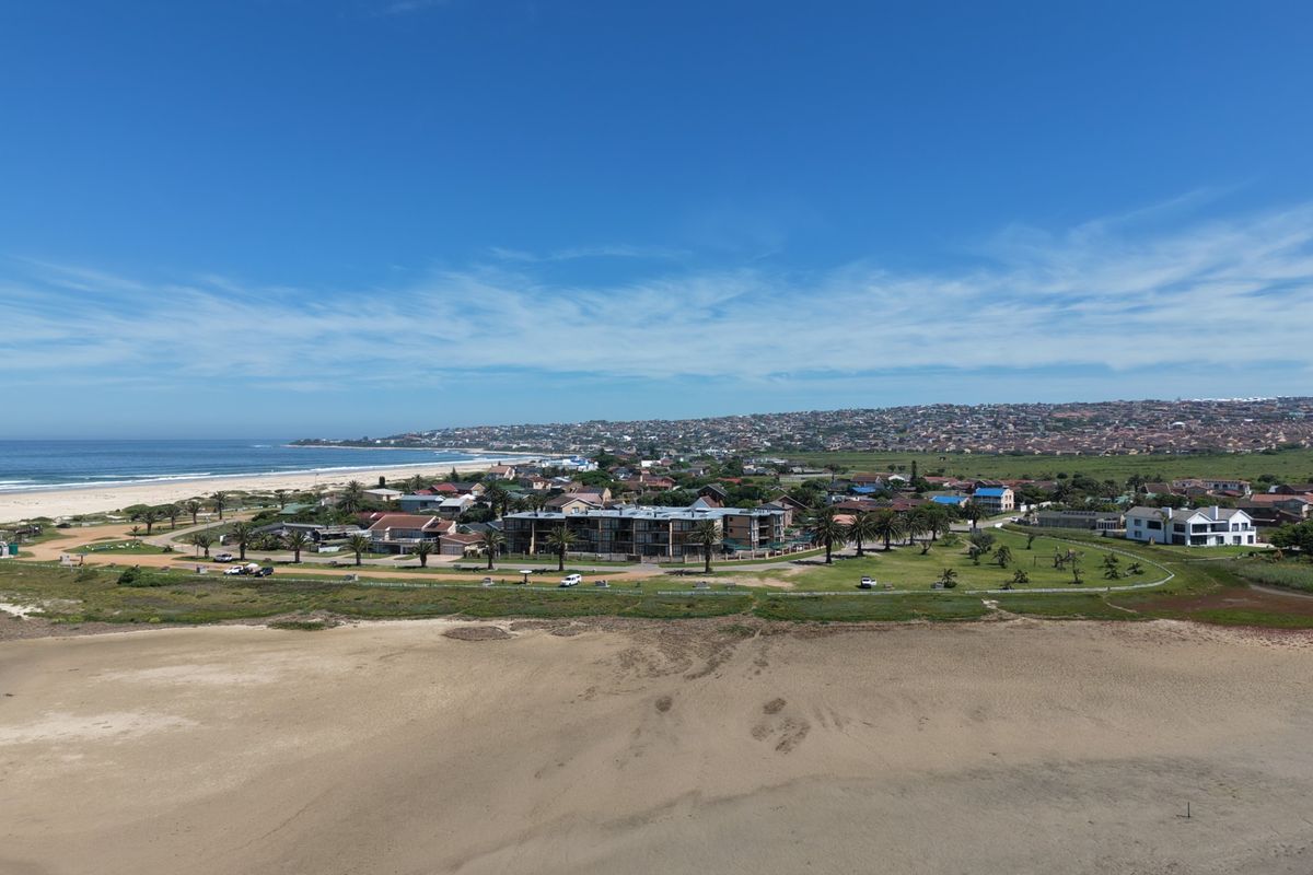 An aerial view of the coastal residential area, showcasing the proximity to the beach and surrounding landscape.
