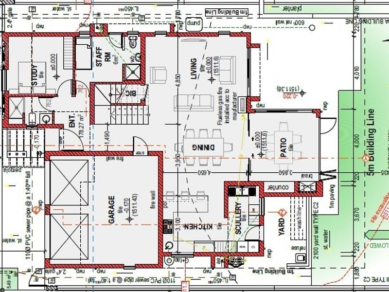 Architectural floor plan showing the layout of the ground floor, including living areas, kitchen, garage, and outdoor patio space.