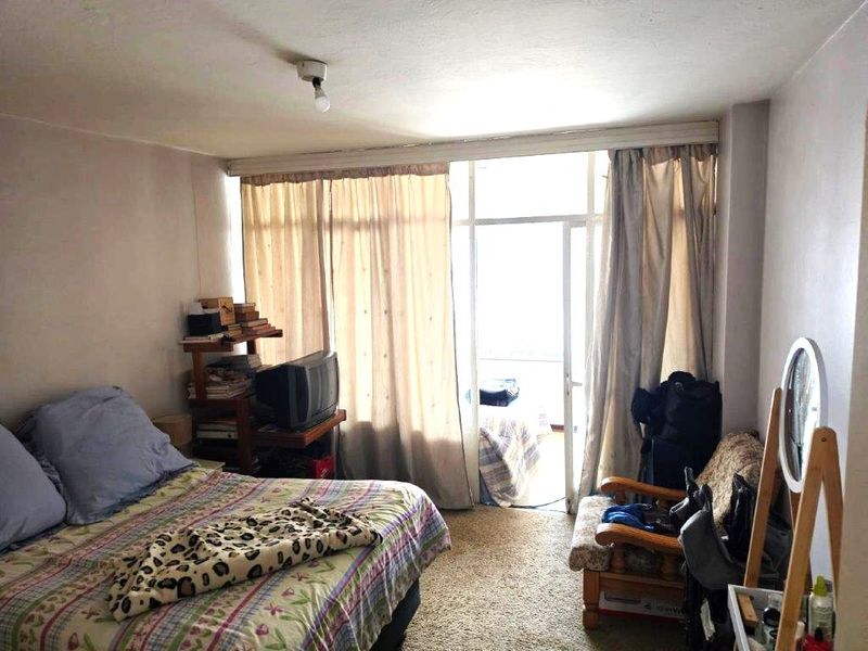A bedroom featuring carpet flooring and a sliding glass door providing access to an outdoor area.